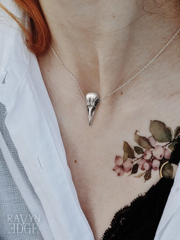 Woman wearing gothic bird skull necklace