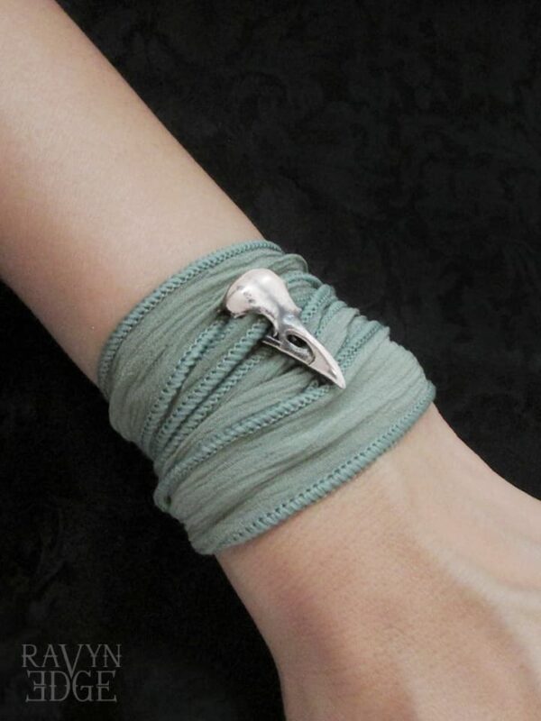 Sage green silk wrap bracelet with silver raven skull