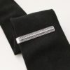 Sterling silver dragon scale tie bar on a black tie