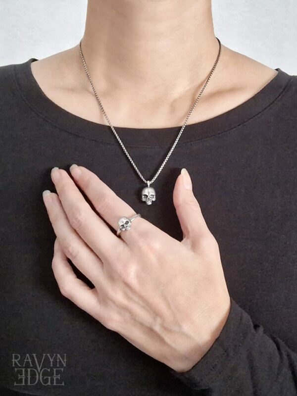 Woman wearing cute gothic skull necklace and ring