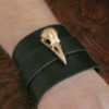 Brass raven skull on a black leather wrist cuff