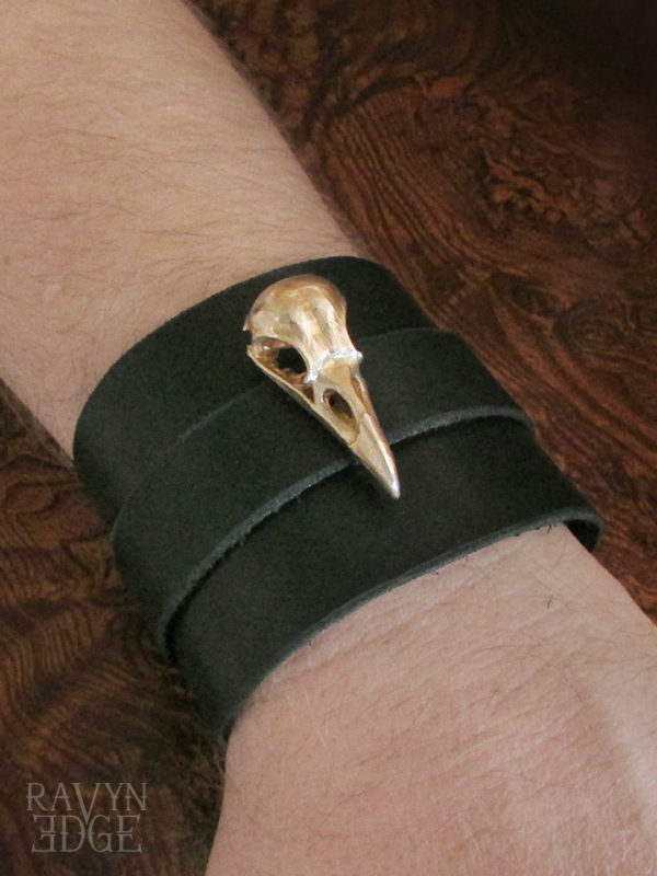 Brass raven skull on a black leather wrist cuff