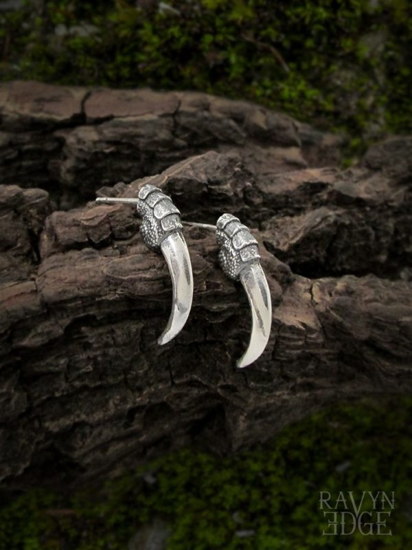 Small silver stud earrings shaped like crow talons