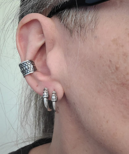 Ear with silver talon earrings in first and second piercings, dragon scale concha ear cuff