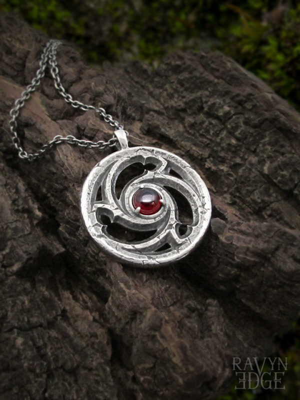 Garnet necklace with sterling silver triskelion spiral cathedral window design