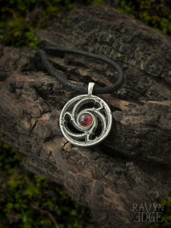 Small sterling silver triskelion gothic window necklace with garnet