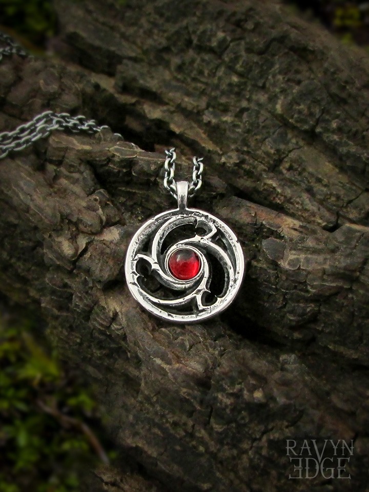 Small triskele window sterling silver garnet necklace