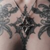 Kellsey wearing the silver star necklace in the center of her quatrefoil gothic tracery tattoo that inspired the pendant necklace.